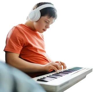 Young boy with down syndrome playing synthesizer BEW